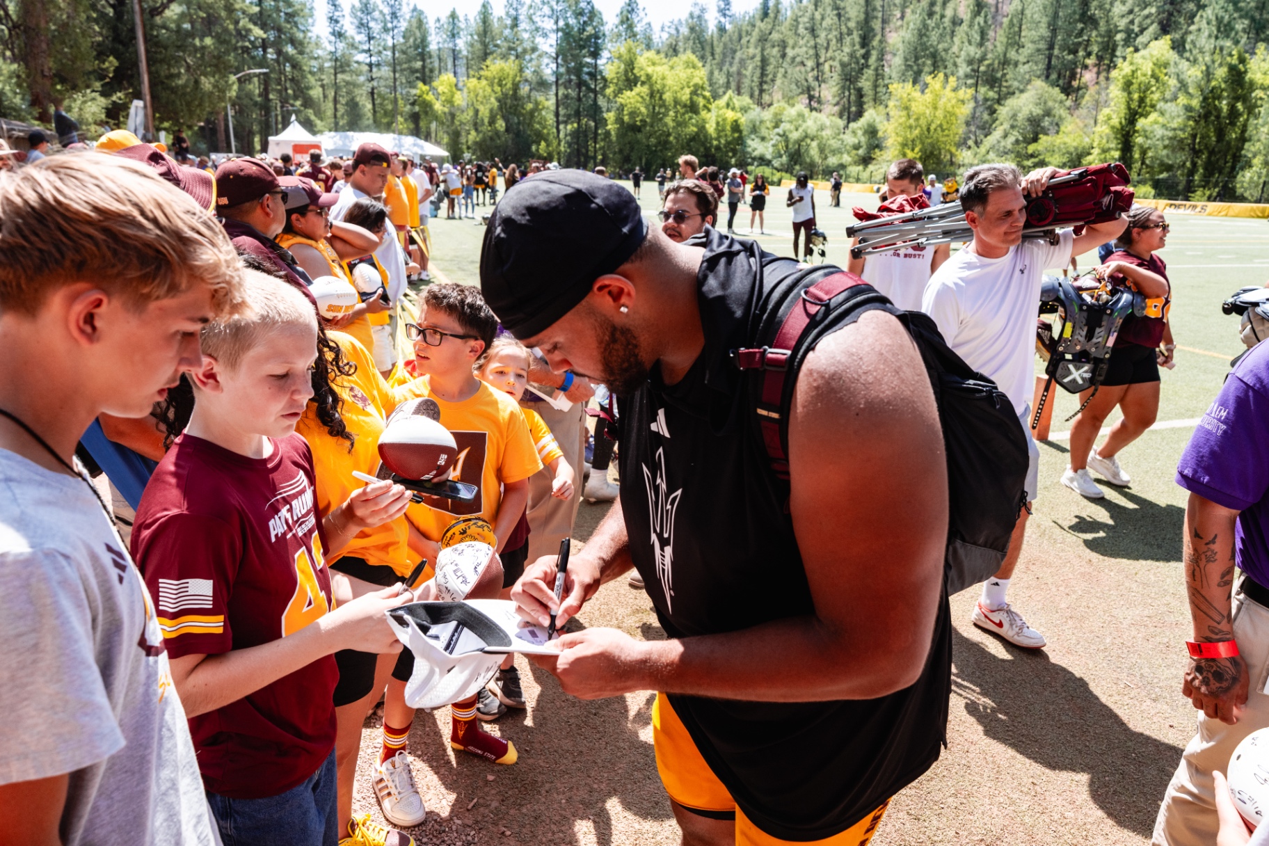 Ben signing autographs for fans at camp